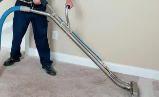 Professional operating a liquid removal machine on a carpeted floor in Norfolk, VA